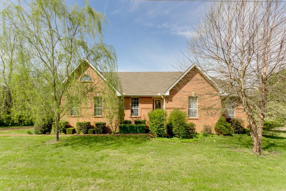 Beautiful mature trees and landscaping to include a lilac bush.