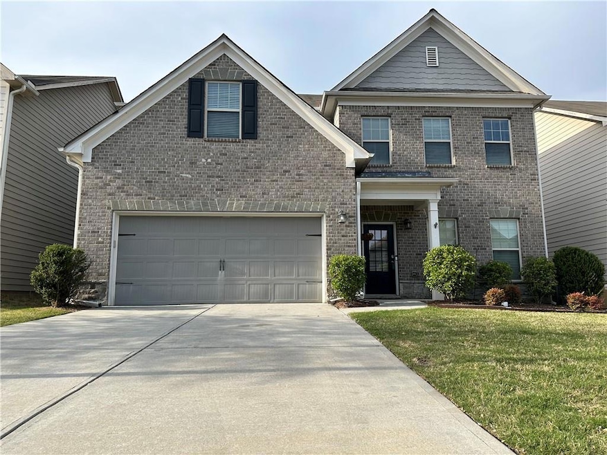 View of front of house featuring driveway, brick s