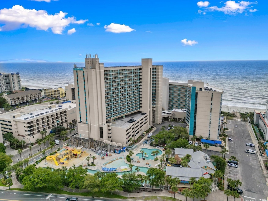 Birds eye view of property with a water view