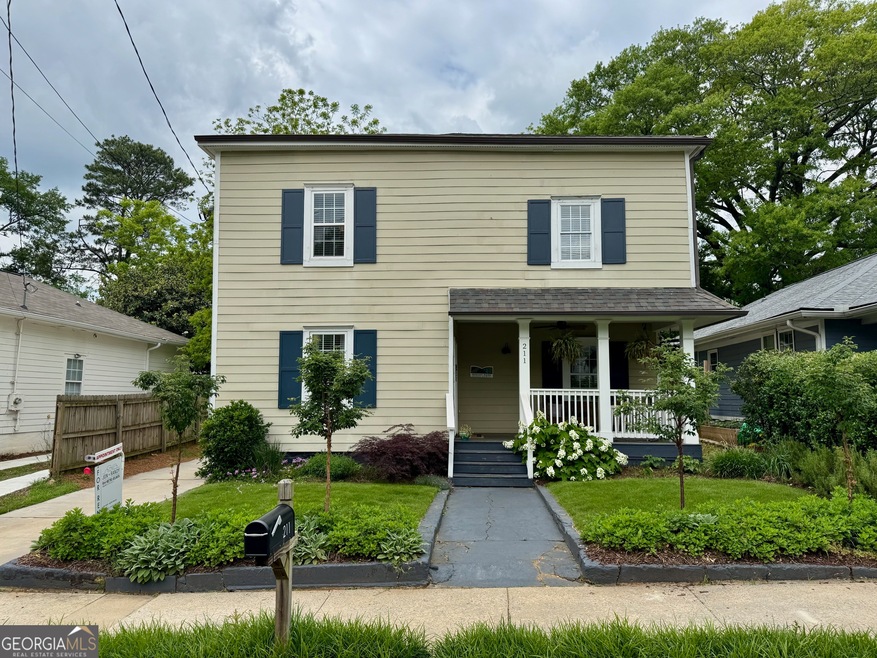 Front porch entry and pretty yard with nice curb a