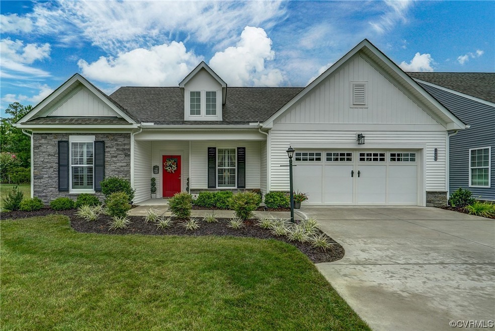 View of front of house with garage, a porch, and a