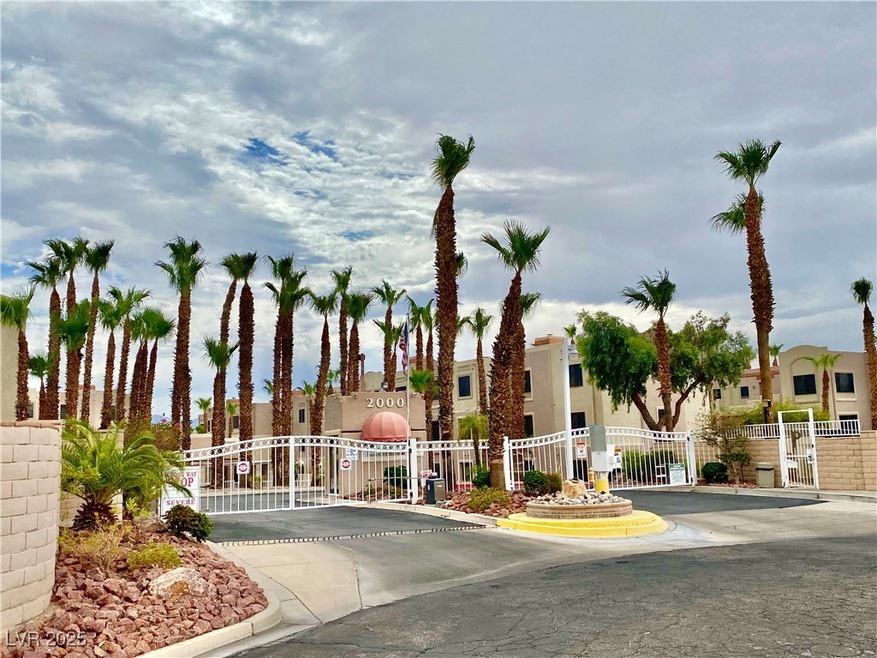 View of road featuring a gate, a gated entry, curb