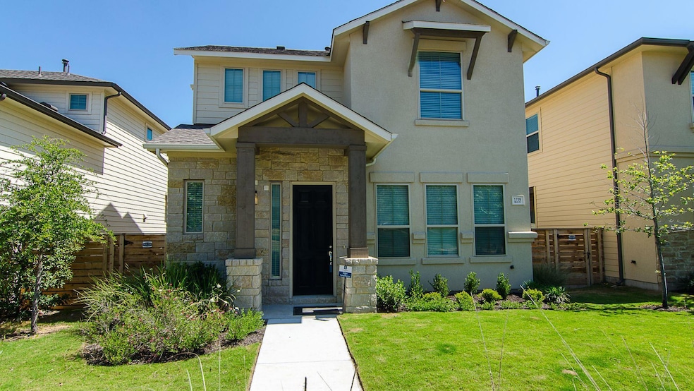 View of front of home featuring stone siding and 