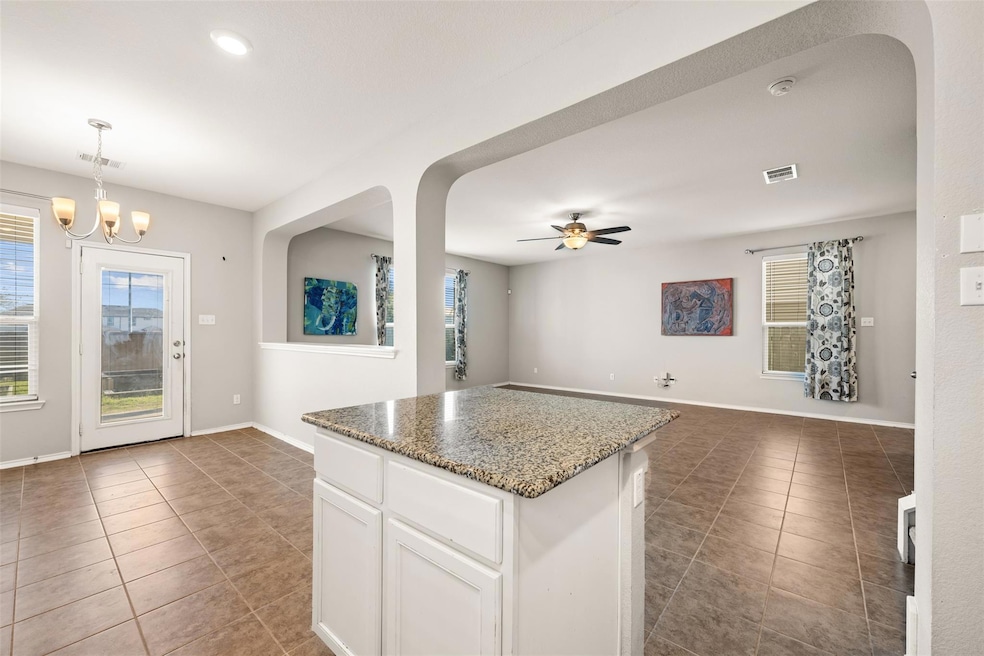 Kitchen with tile patterned floors, ceiling fan, 