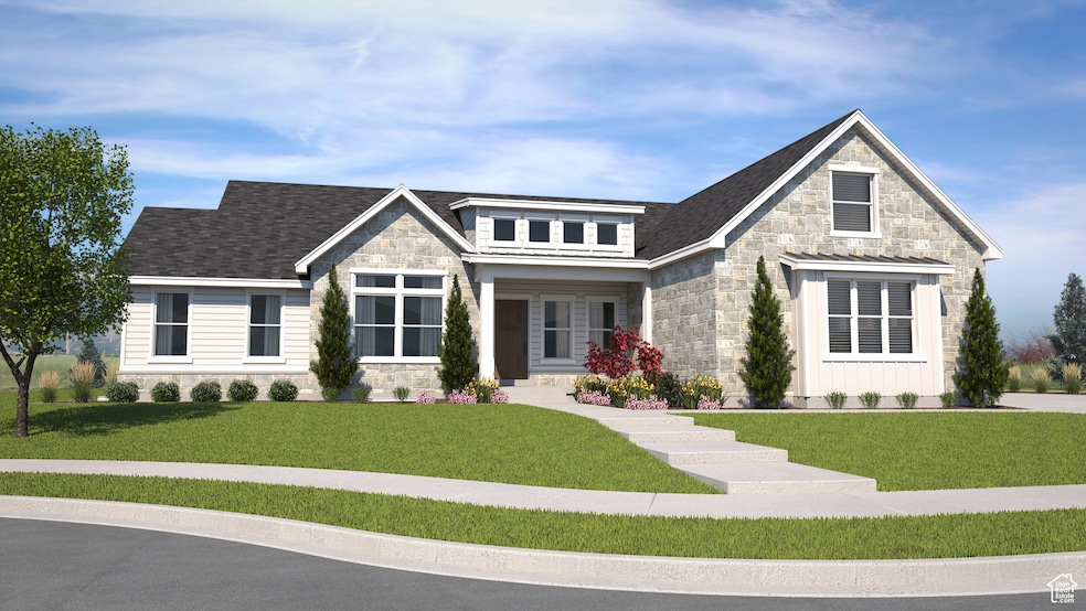 View of front of property with stone siding, a porch, a front yard, and roof with shingles