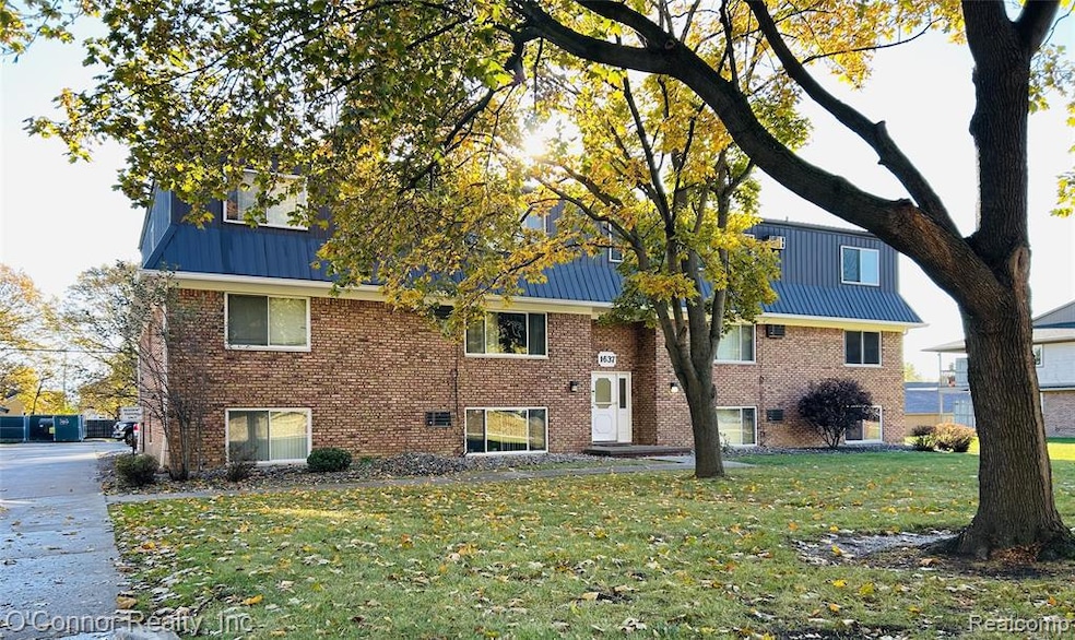 Living room featuring wood finished floors and a wall mounted air conditioner