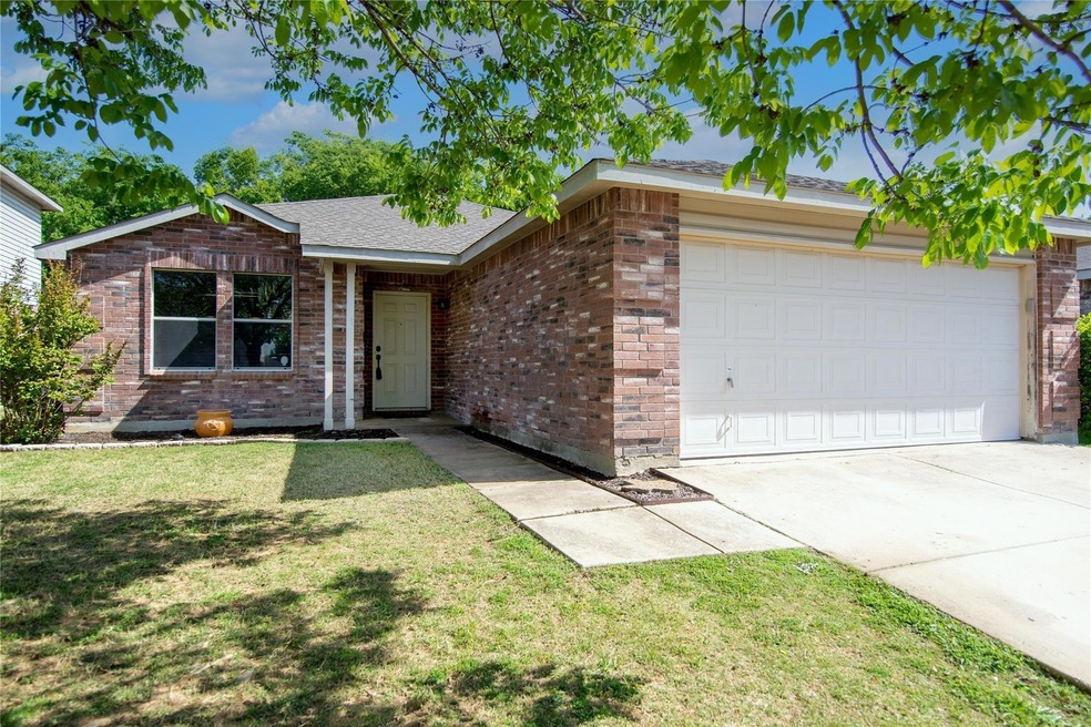 Ranch-style house with a front yard and a garage