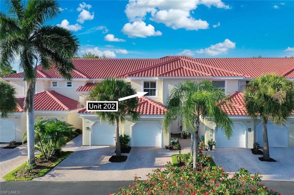 Exterior of Glenmoor Greens coach homes with garages featuring a tile roof, stucco siding, and driveway