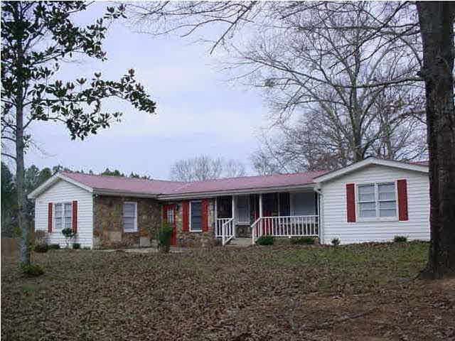 Front view of house with vinyl siding and stone