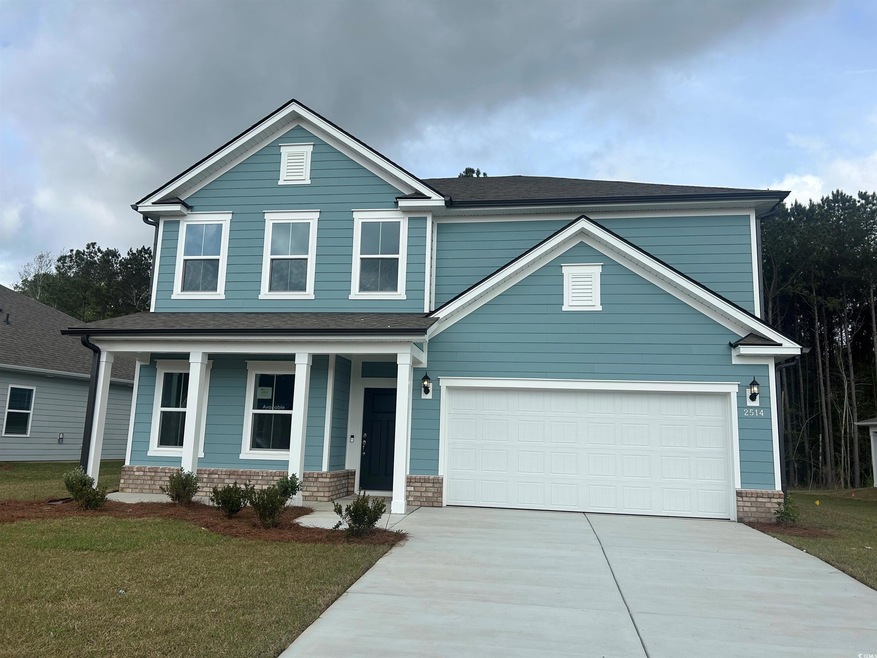 View of front of home with an attached garage, a f