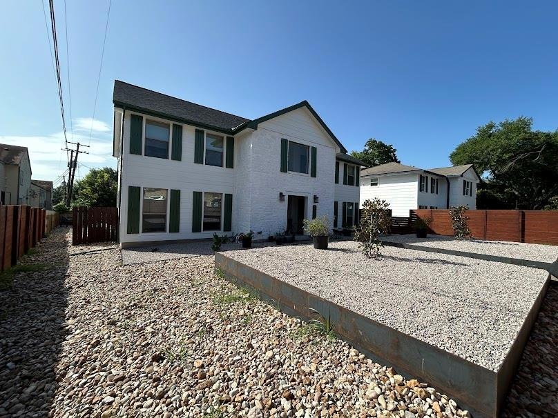 Rear view of property featuring a fenced backyard