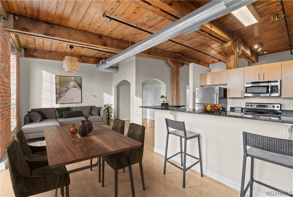 Interior space featuring wood ceiling, brick wall,