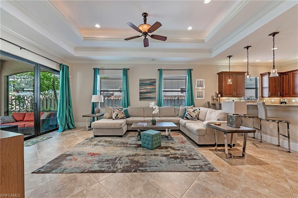 Great Room room featuring crown molding, a raised 