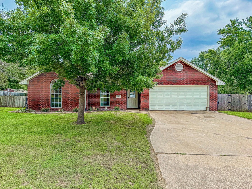 View of front of property with a front lawn and a garage