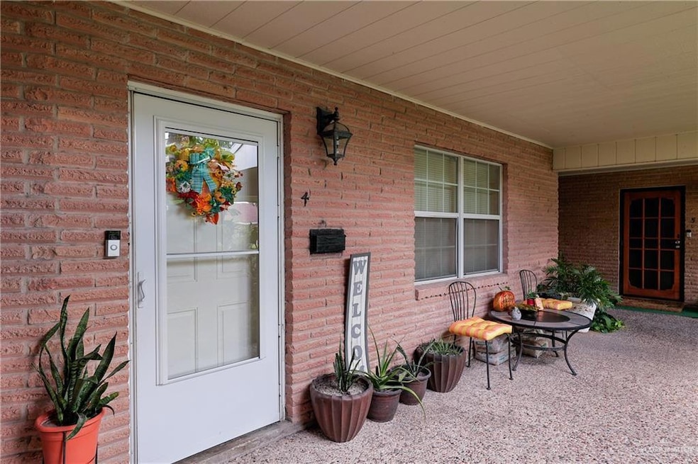 Property entrance featuring brick siding