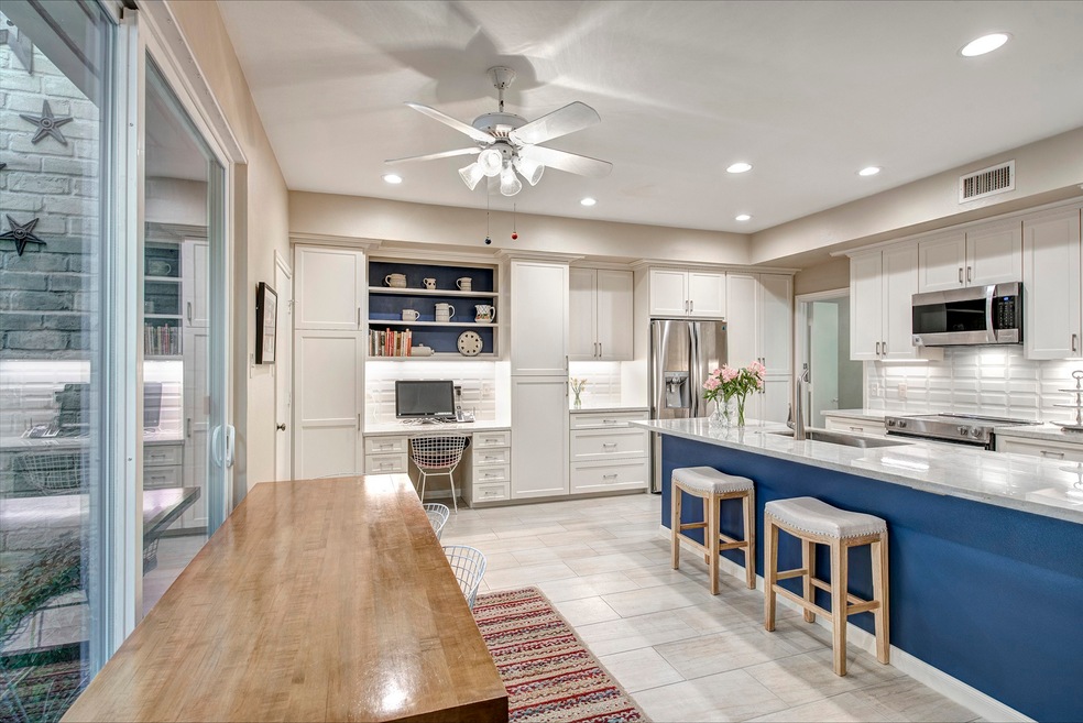 Chef's kitchen features quartzite peninsula and co