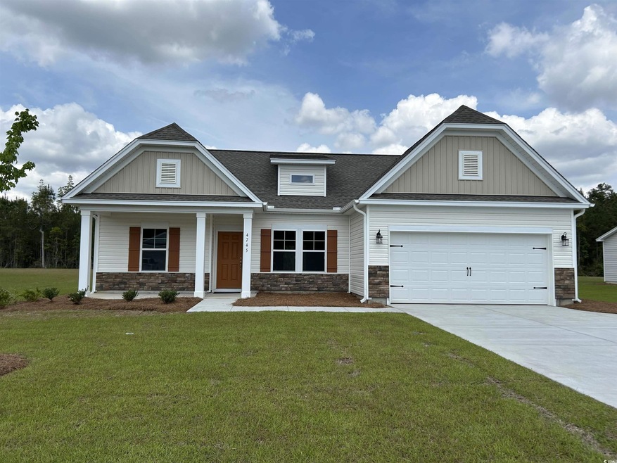 Craftsman-style home with a front lawn, driveway, 