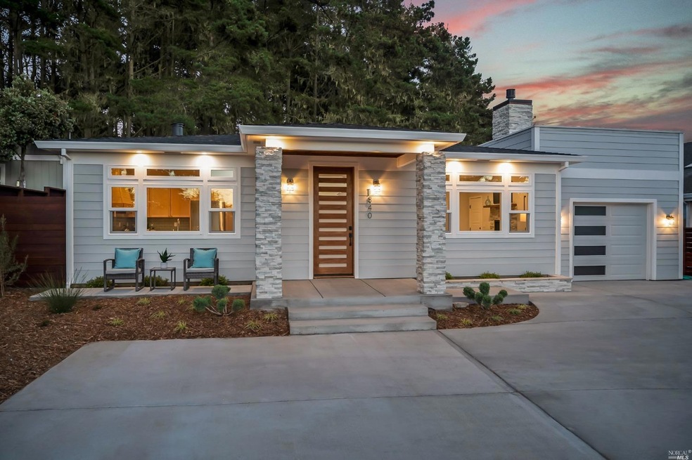 Front of House with patio, a one car garage and tw