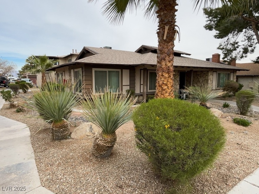 View of front of house with stone siding and a shi