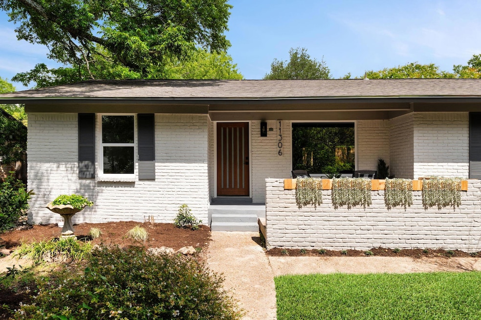 View of front of home with brick siding and a shi