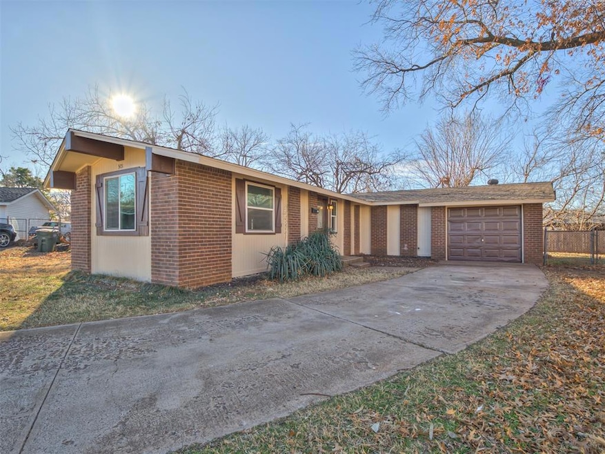 View of front of home with driveway, brick siding,