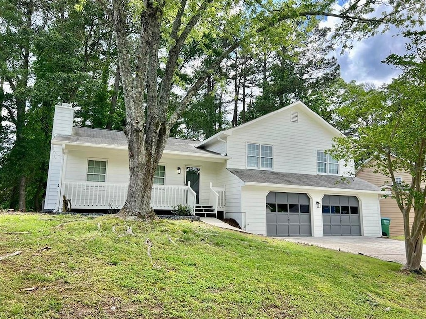 Tri-level home with an attached garage, a front ya