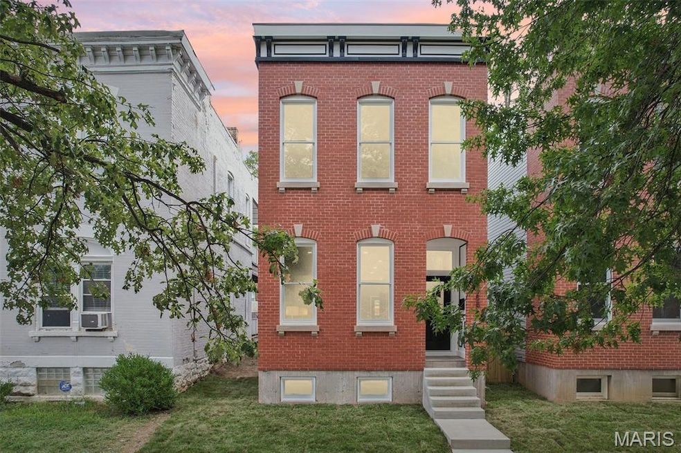 Italianate house featuring brick siding and a front lawn