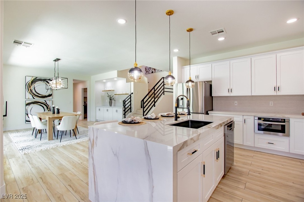 Kitchen featuring light wood-style flooring, a sin