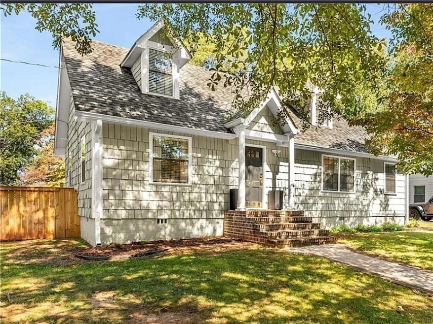 View of front of home with crawl space and roof with shingles
