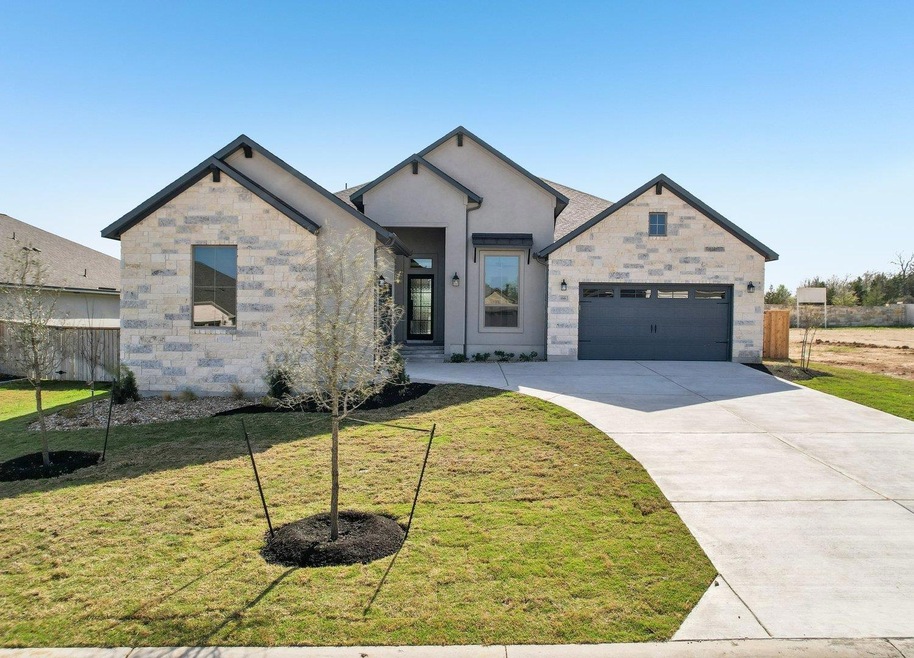 View of front facade with a front lawn, concrete 