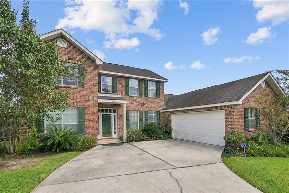 Prestigious Front, concrete driveway, and covered