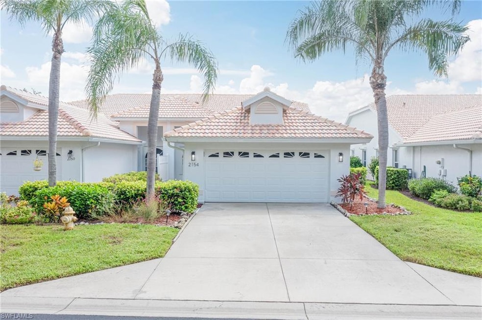 Ranch-style house with a front yard, a tile roof, 