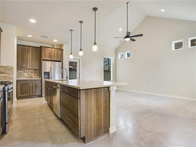Open kitchen with stainless steel appliances.
