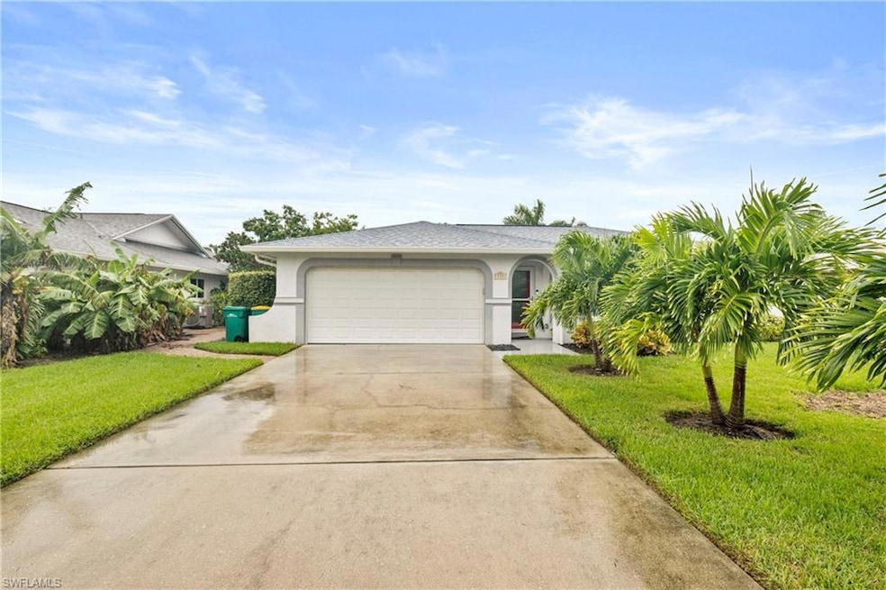 Single story home with a garage and a front yard