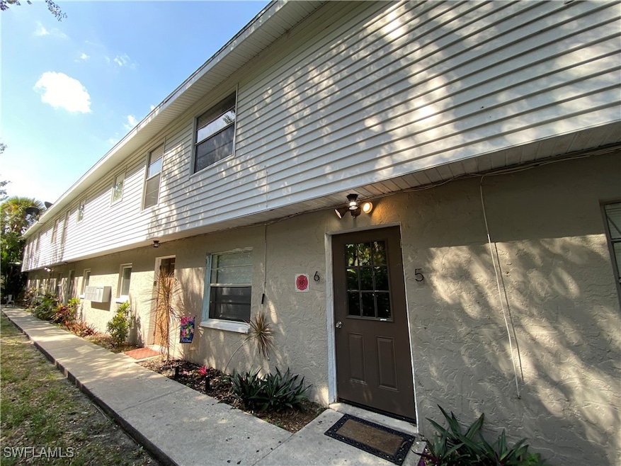 View of exterior entry featuring stucco siding