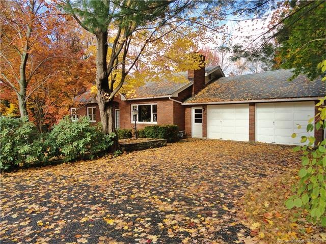 Front of house with 2 car garage & large paved dri