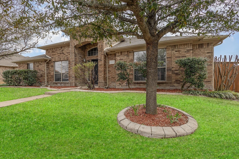 View of front of property with a front lawn, fence