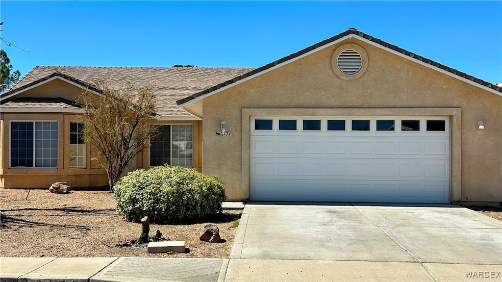Single story home featuring concrete driveway, an