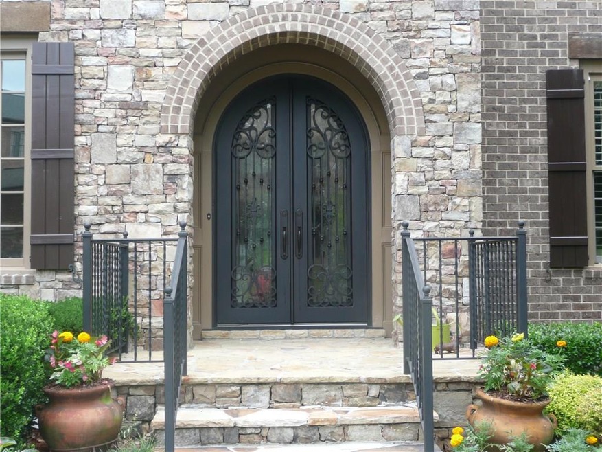 Beautiful iron doors in covered entry.