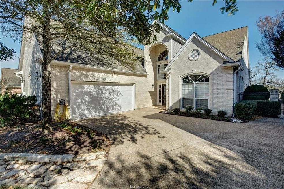 View of front of house with concrete driveway, an