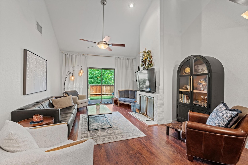 Living room with high vaulted ceiling, wood finis