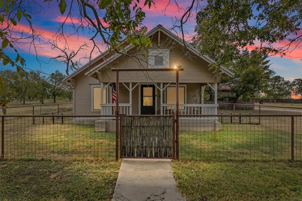 Bungalow-style house with covered porch, a gate, 