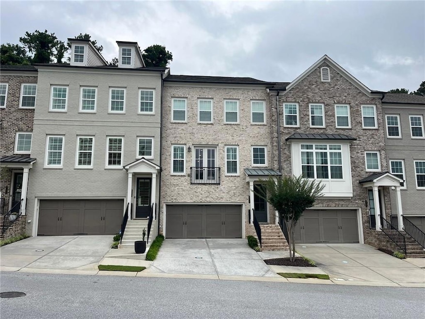 View of property with a garage and driveway