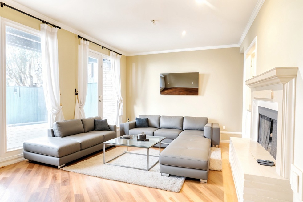 This family room features gleaming wood floors and