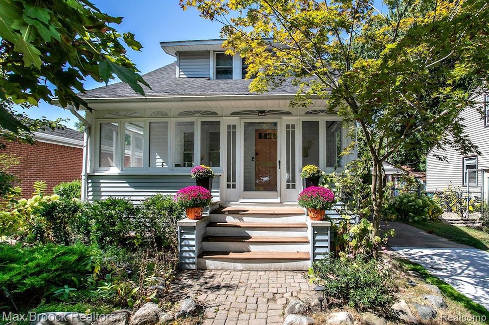 Bungalow-style home with roof with shingles and covered porch