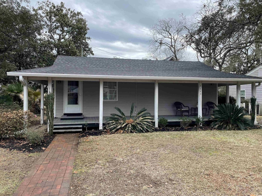 View of front of home with roof with shingles, a porch, and a front lawn
