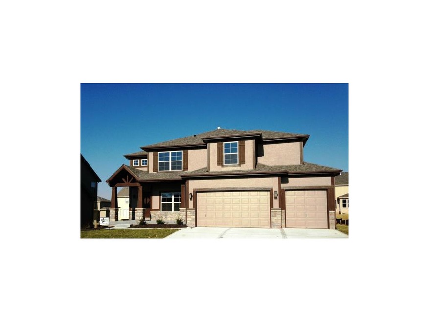 Stucco and stone front elevation.