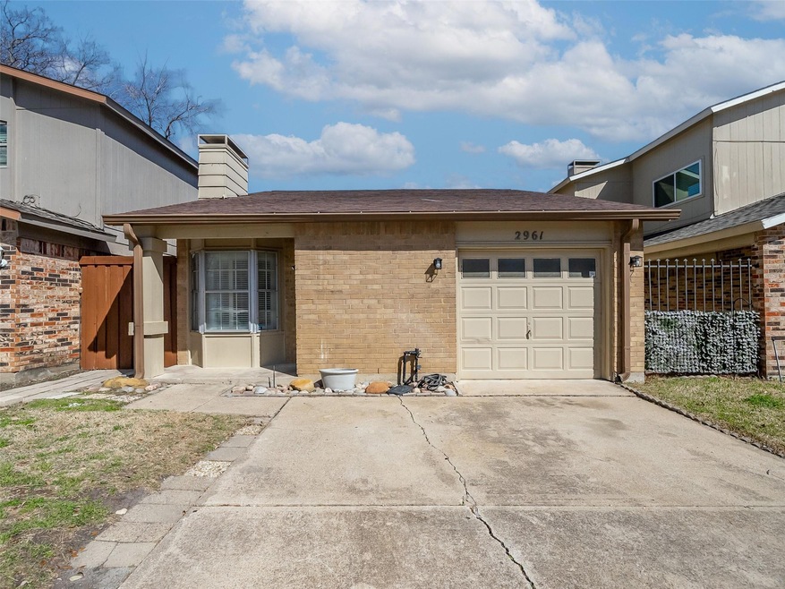 View of front of home featuring driveway, brick si