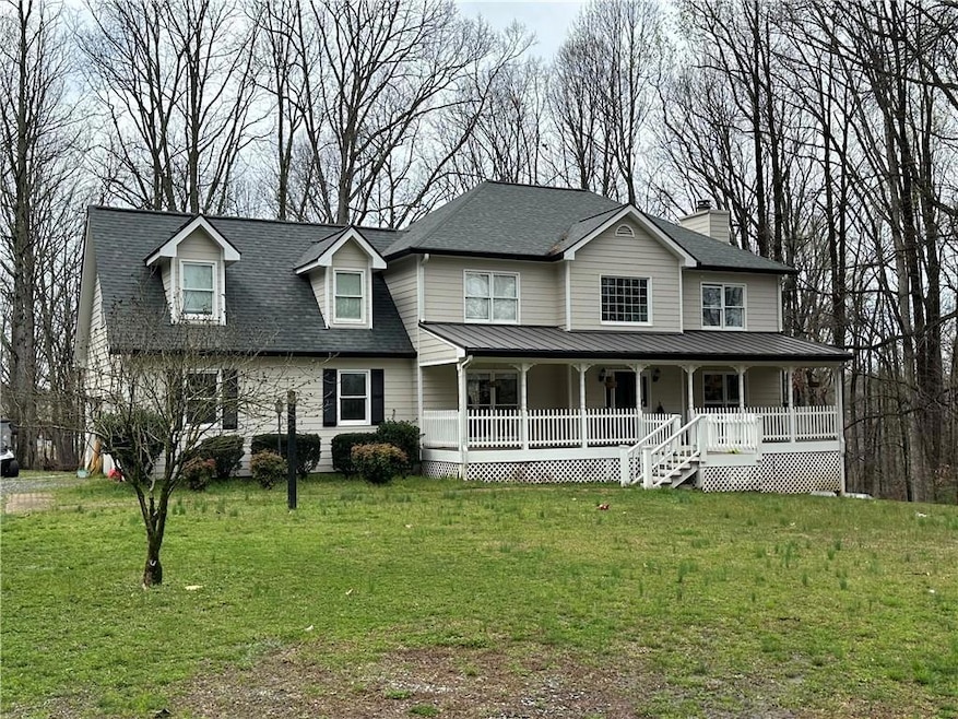 View of front facade with a front lawn and a porch