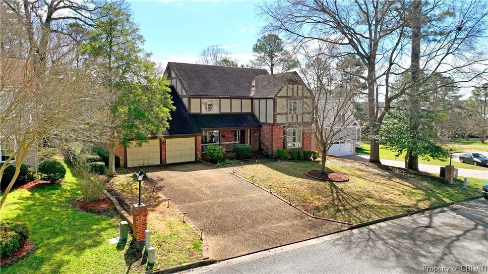 Tudor house with a front lawn and a garage